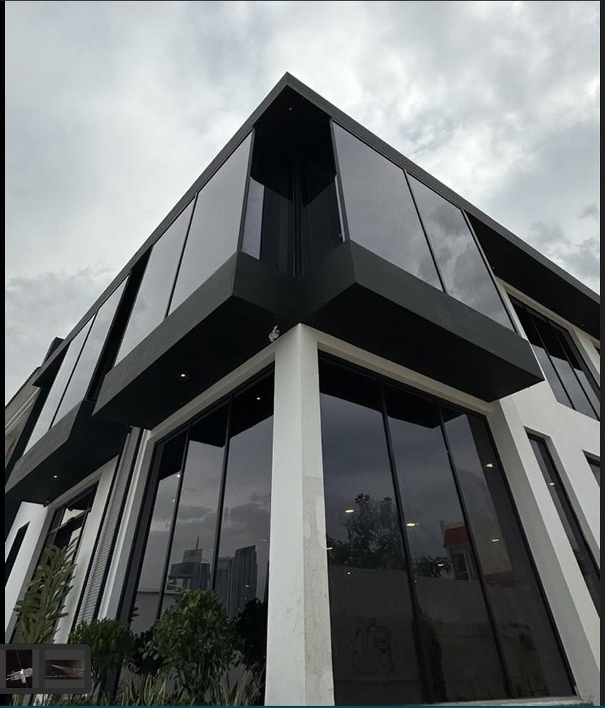Contemporary angular architecture with dark glazing, representing the HST design language