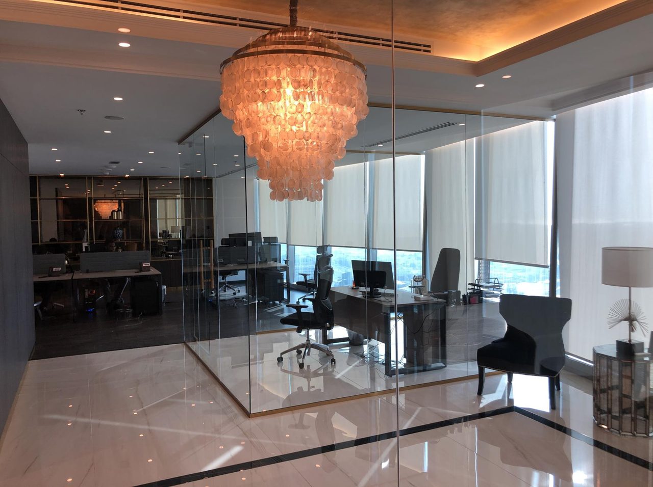 HST Architects designed office interior in Dubai with a chandelier and floor-to-ceiling city views