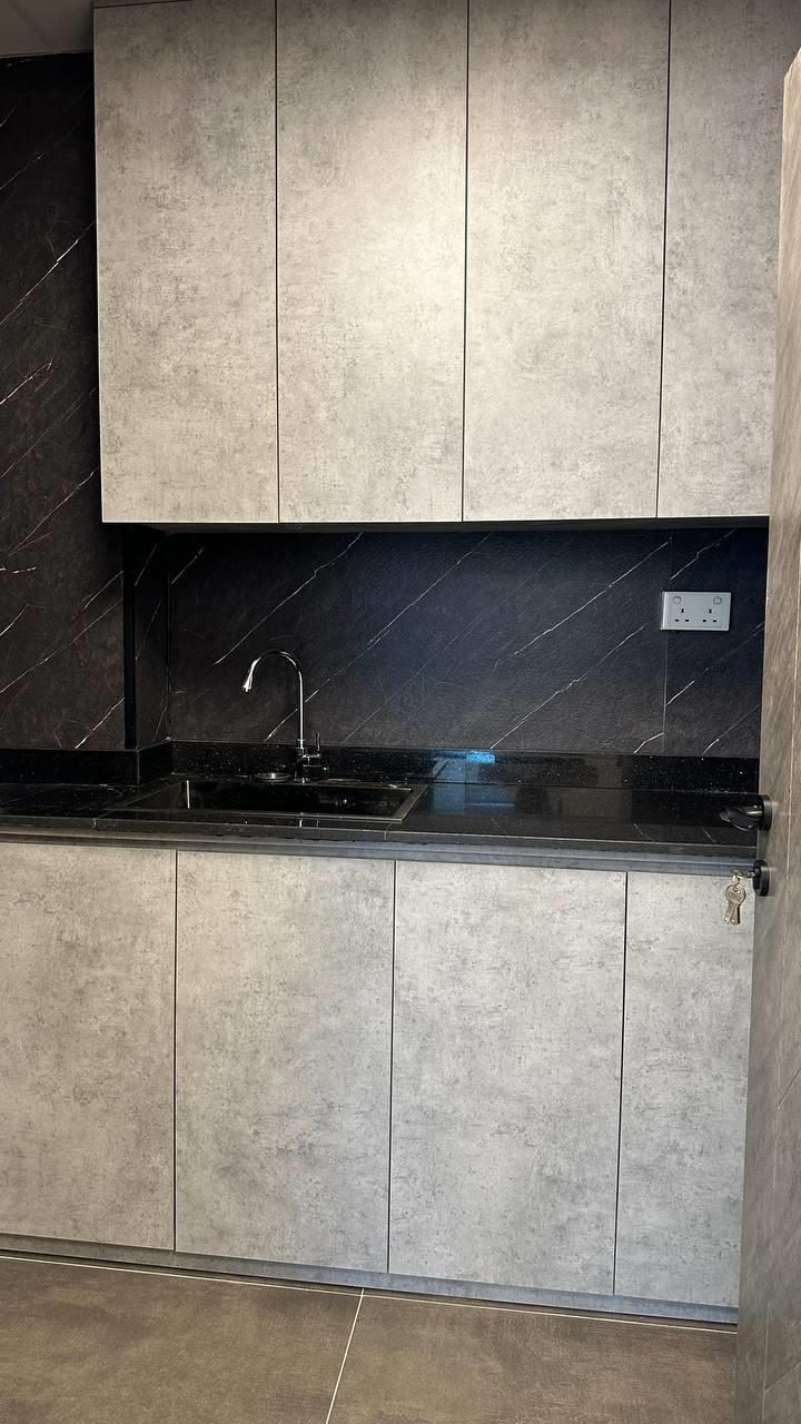 Concealed pantry run in dark stone with integrated appliances