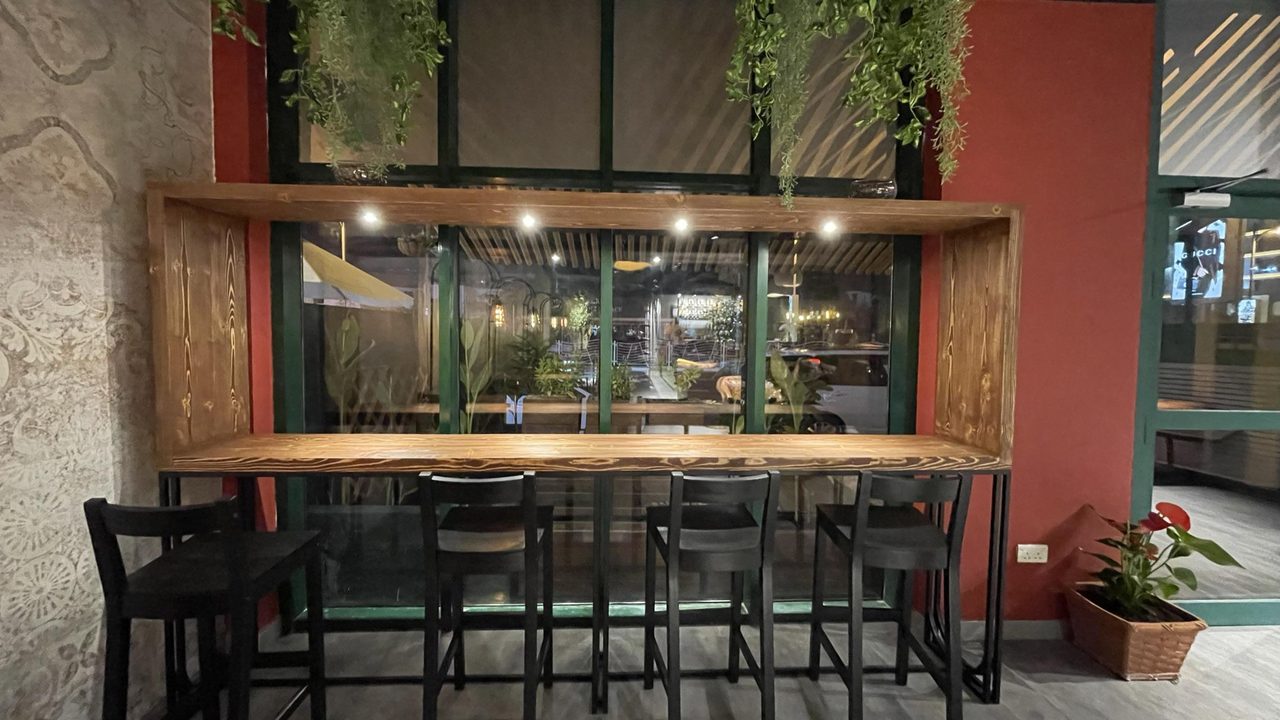 Café terrace with a red framed façade and timber shopfront