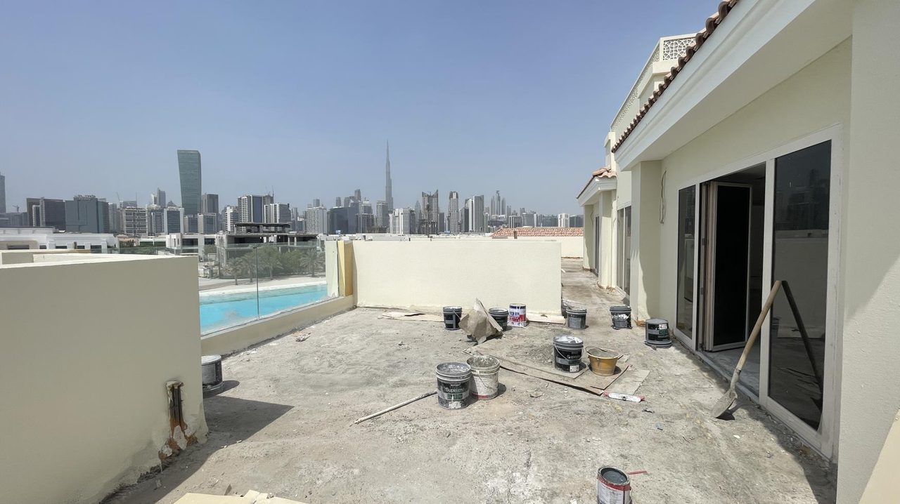 Roof terrace under construction with the Dubai skyline behind