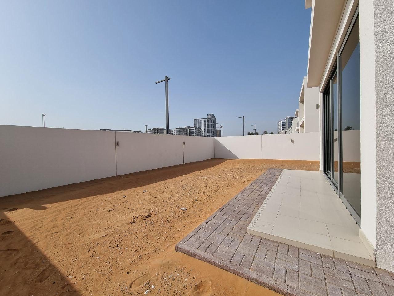The plot before works, showing bare ground and boundary walls