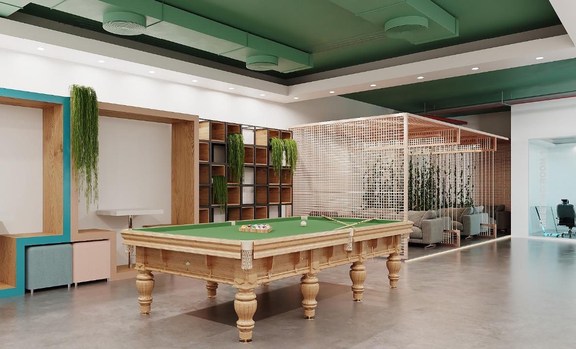 Breakout lounge with a pool table, library shelving and planting