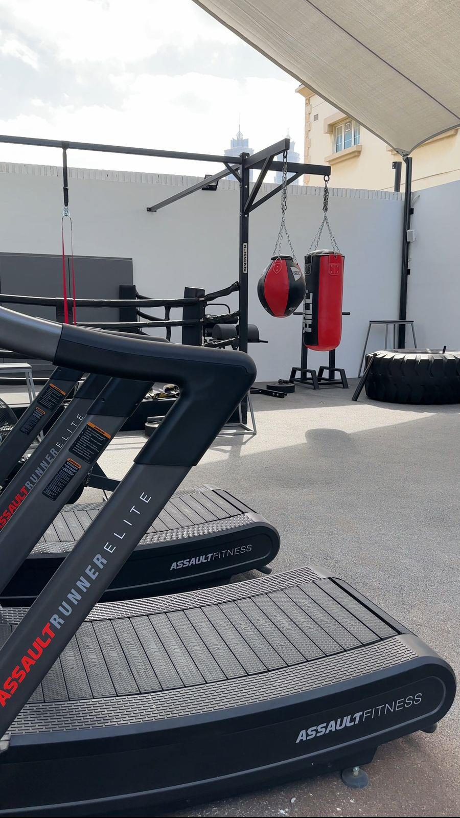 Cardio zone with treadmills facing full-height glazing