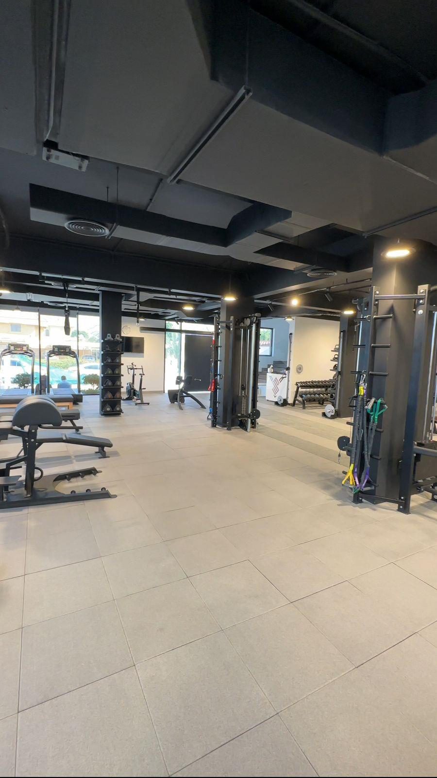Free-weights floor with rubber matting and mirrored walls