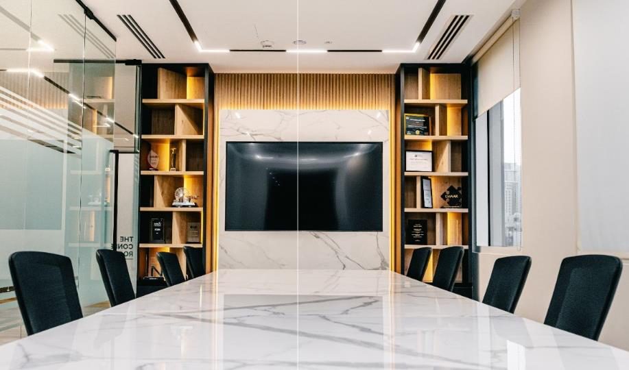 Boardroom with a stone table, joinery wall and integrated screen