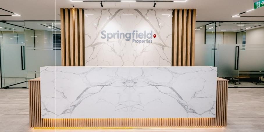 Reception counter in book-matched stone with warm concealed lighting