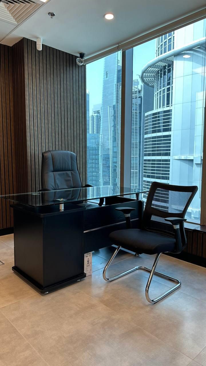 Executive office with a stone desk and floor-to-ceiling views over Business Bay